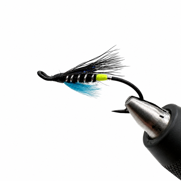 Blue Charm fishing lure with blue feather tail and lime accent body