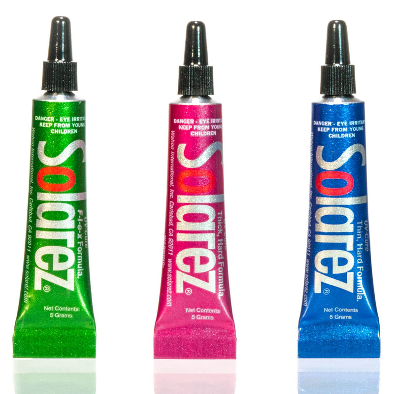 Load image into Gallery viewer, Three UV-cure fly-tie tubes in green, pink, and blue with black nozzles
