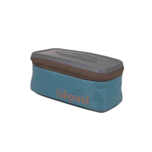 Medium reel storage case with teal body, dark gray lid, and Fishpond logo