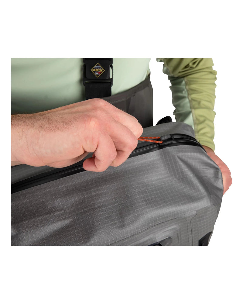 Load image into Gallery viewer, Olive-gray sling backpack close-up of zipper pull on top opening
