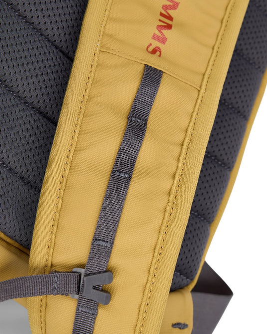 Simms Tributary sling pack, yellow web strap with Simms logo and gray mesh backing