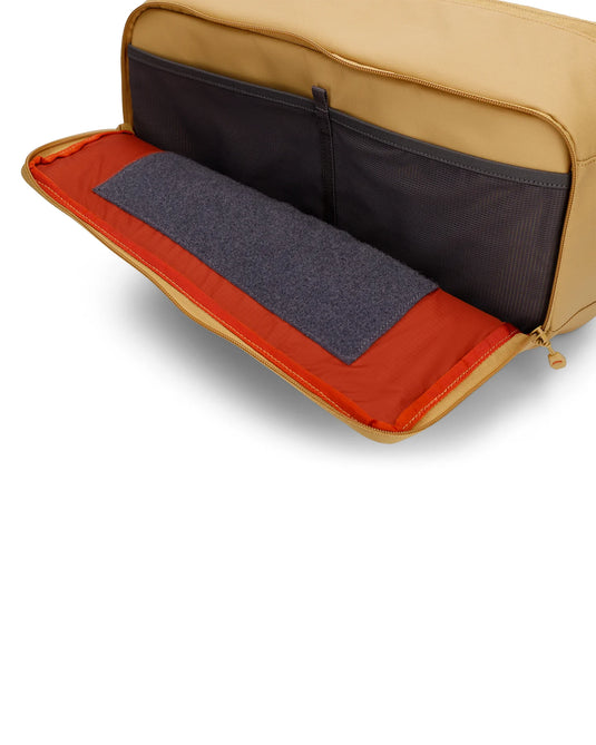 Simms Tributary sling pack, open interior with dark insert and orange trim