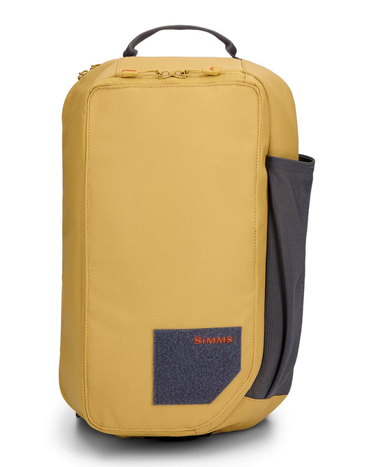 Simms Tributary sling pack, tan front panel with Simms patch and carry handle