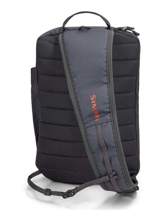 Simms Tributary sling pack, dark back panel with padded straps and top carry handle