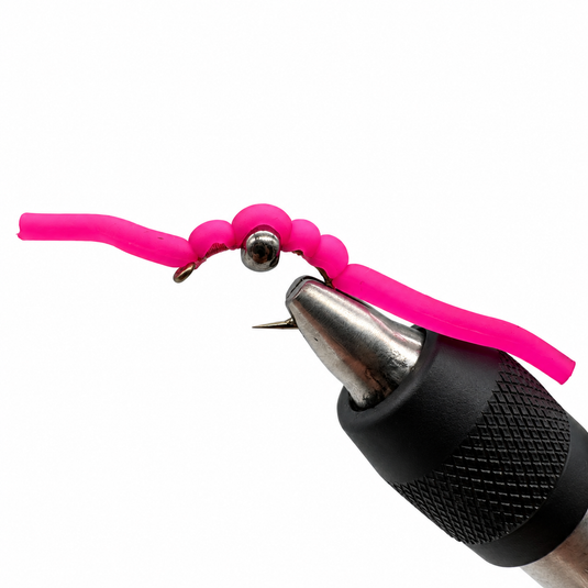 Pink squirmy worm fishing lure with silver hook and black foam jig head