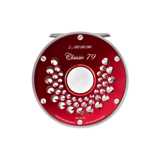 Red fishing reel spool with perforated ring and circular center opening