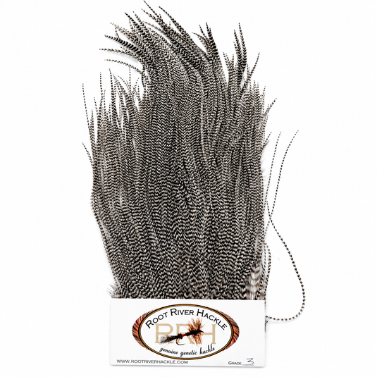 Root River Saddle feather tuft in dark gray and black speckled fibers