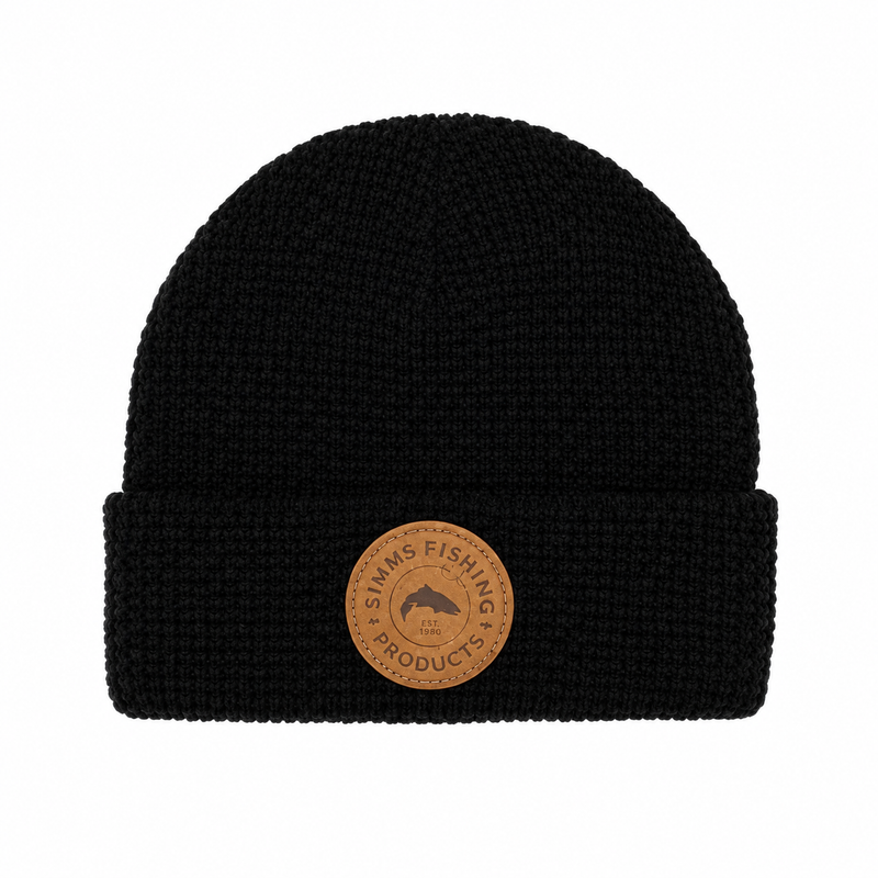 Load image into Gallery viewer, Black waffle-knit beanie with fold cuff and round Simms Fishing Products leather patch
