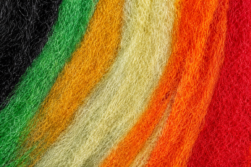 Load image into Gallery viewer, Betts Z-Lon yarn strands in mixed green, orange, red, yellow, and black
