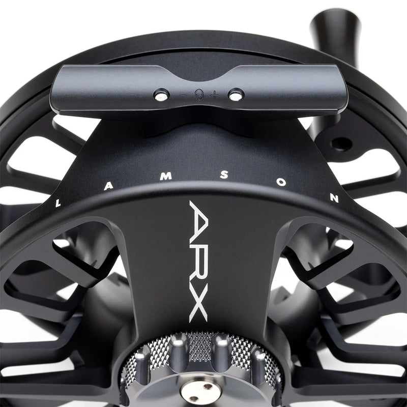 Load image into Gallery viewer, Fly fishing reel side view with engraved brand mark and knurled grip rim
