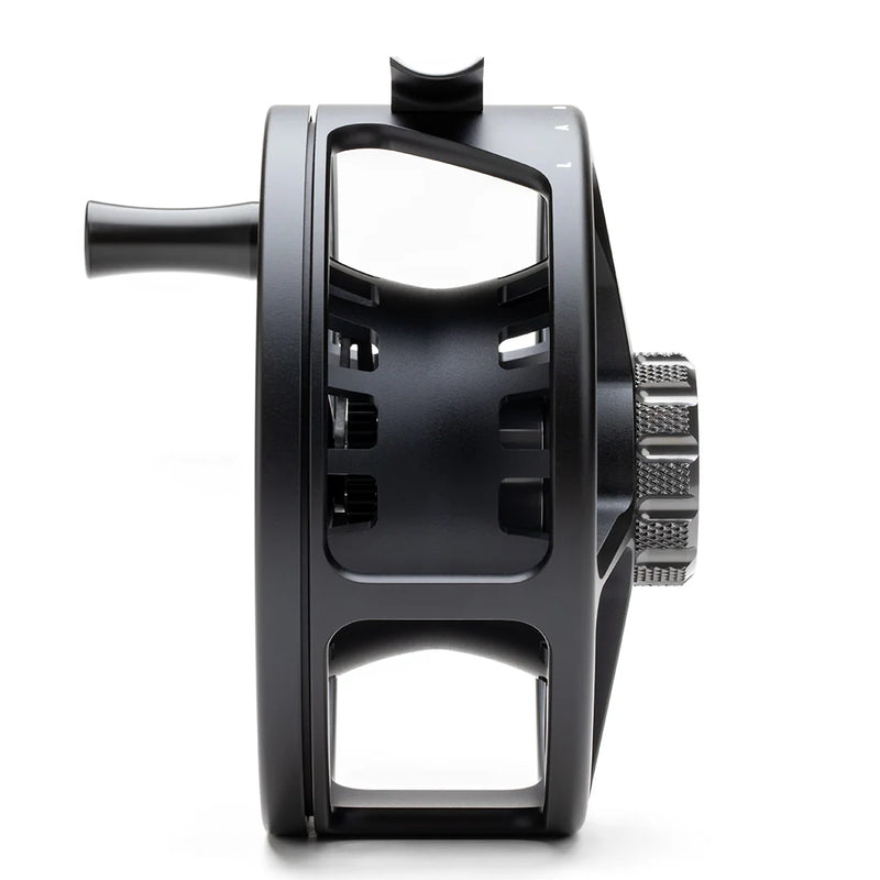 Load image into Gallery viewer, Fly fishing reel back view with frame cutouts and textured adjustment wheel
