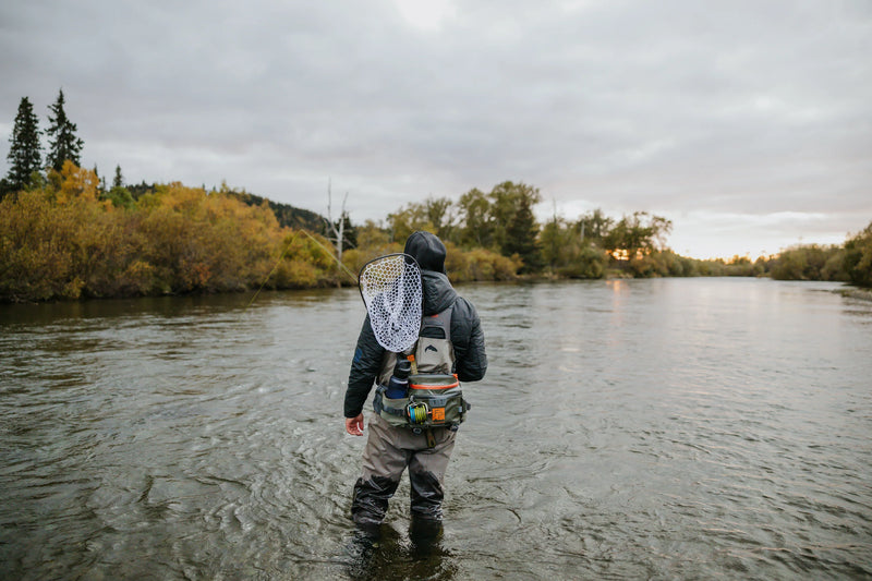 Load image into Gallery viewer, Gray and olive waist pack with orange accents on angler’s back
