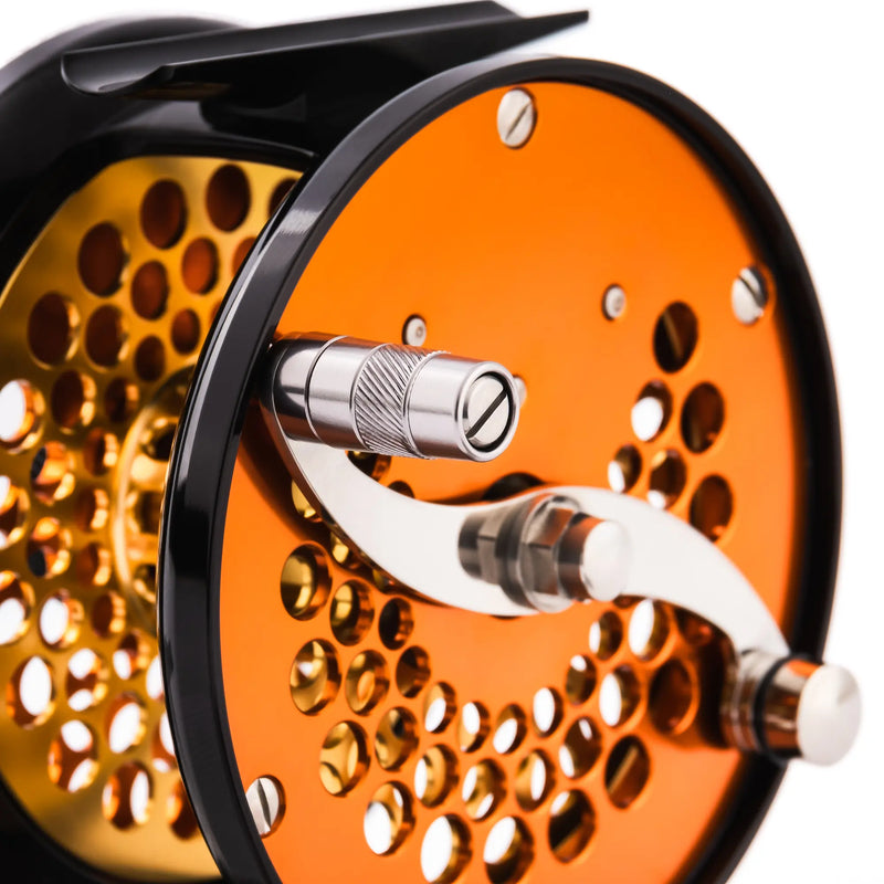 Load image into Gallery viewer, Orange fishing reel with metal handle and perforated spool face
