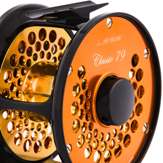 Orange fishing reel with perforated spool and dark center drag knob