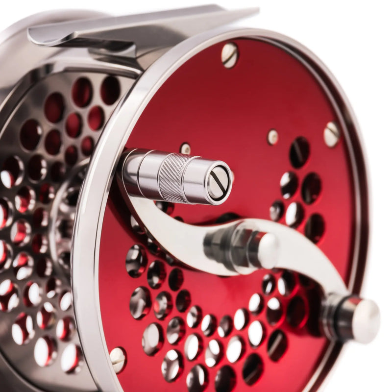 Load image into Gallery viewer, Red fishing reel with metal handle and perforated spool face
