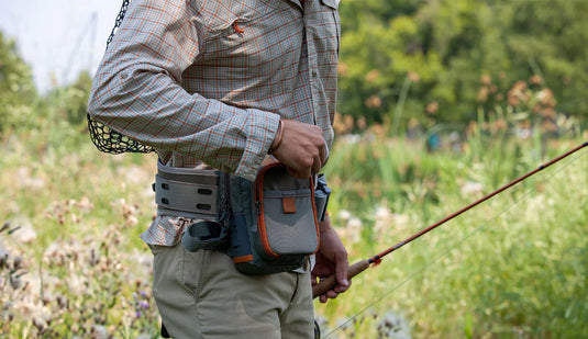 Chest pack side view with orange-edged pocket and gray harness straps