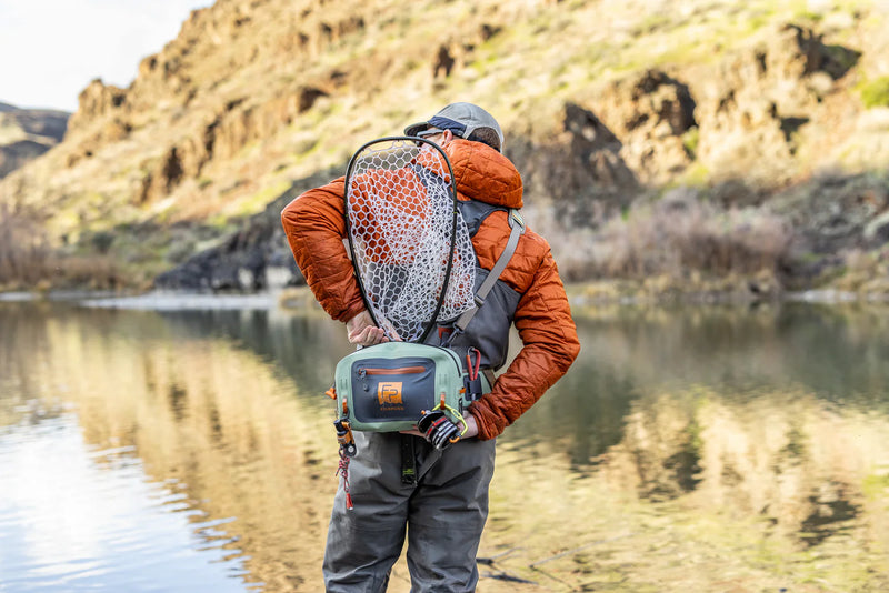Load image into Gallery viewer, Lumbar submersible pack worn with orange accents, olive body, and adjustable shoulder straps
