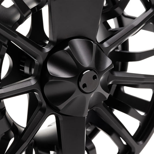 Close-up of black fly fishing reel hub with spoke arms.