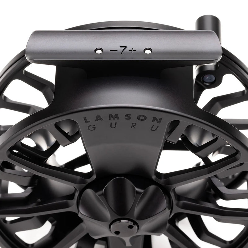 Load image into Gallery viewer, Black fly fishing reel with top bar and engraved center badge.

