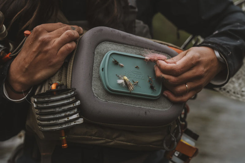 Load image into Gallery viewer, Fly dock pad with teal insert holding assorted flies in gray padded case
