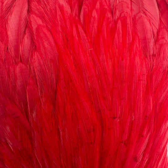 Red feather-like fringe cape fabric close-up