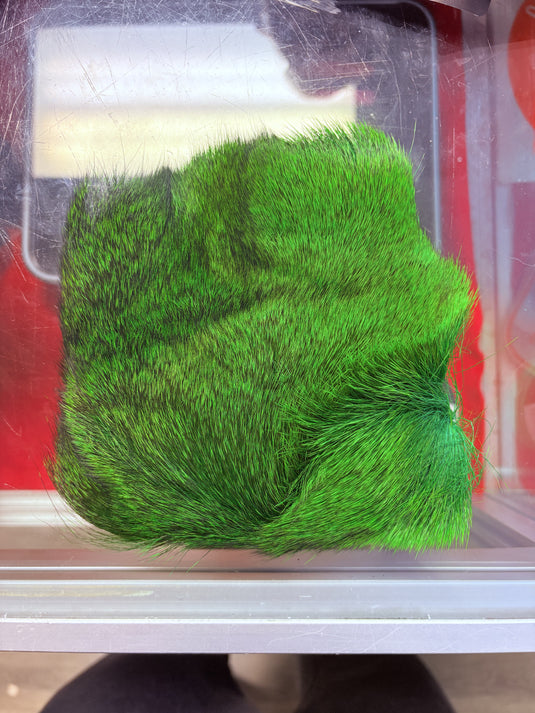 Bright green dyed deer hair patch in clear plastic sleeve