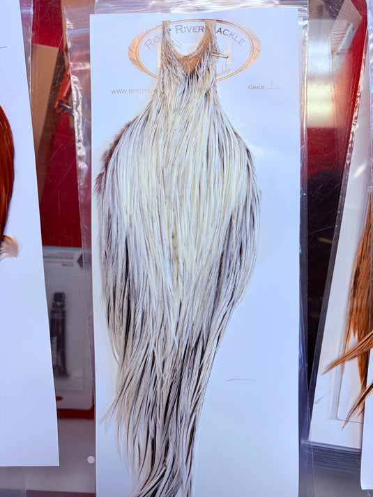 White and gray hackle feather bundle with long tapered body and thin trailing fibers