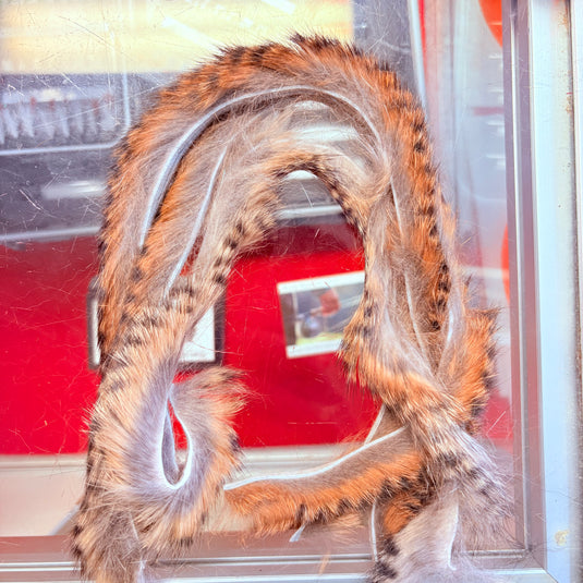 Fishing rabbit fur strips in brown and tan with white highlights, wavy loops