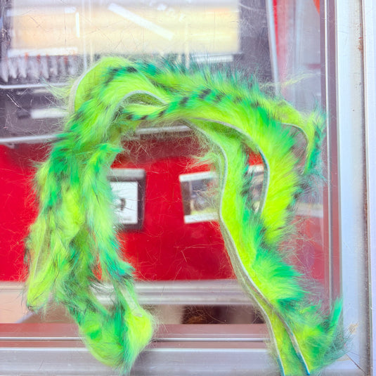 Fishing rabbit fur strips in neon green with purple-blue speckles, wavy loops