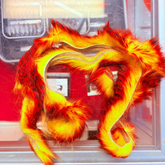 Fishing rabbit fur strips in fiery orange, yellow, and red with wavy loops