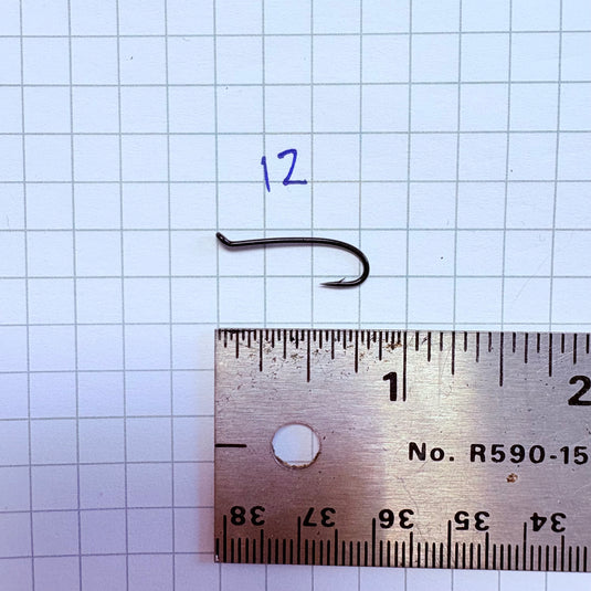 Fishing hook size 12, dark metal, curved shank with barbed tip
