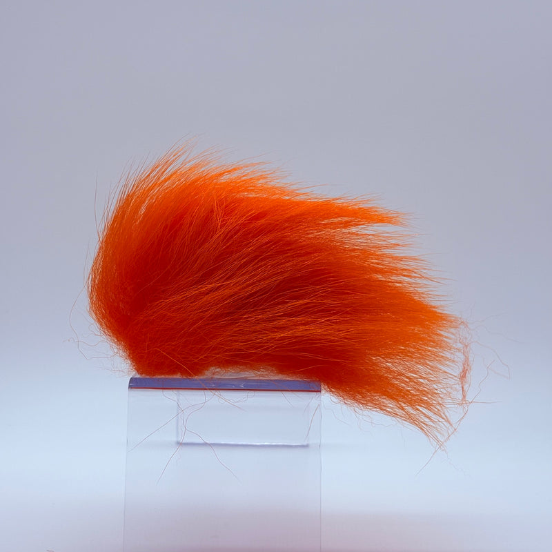 Load image into Gallery viewer, Polar bear plush in orange faux fur tuft.
