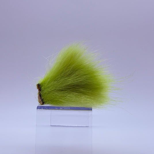 Polar bear plush in chartreuse green faux fur tuft.