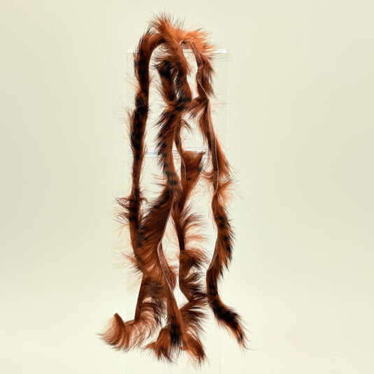 Rabbit fur strip with brown and dark barred fibers