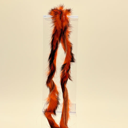 Rabbit fur strip with orange and black barred fibers