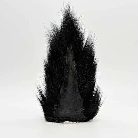 Black bucktail-style fly tail with dark base