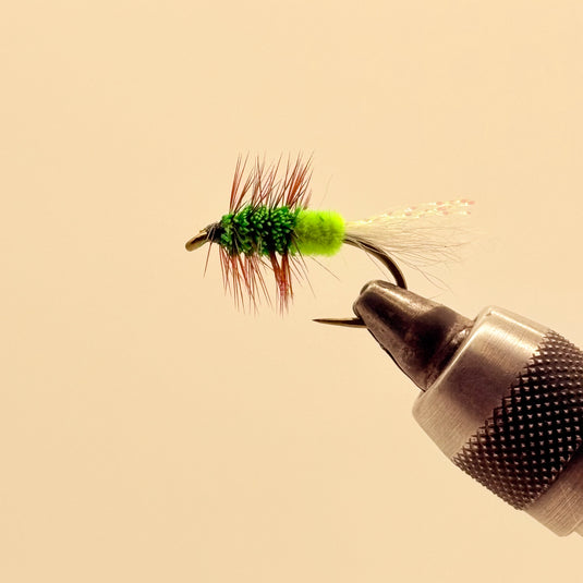 Green fishing lure with lime head, dark green body, red-brown and white fibers