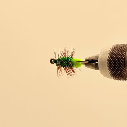 Fishing lure with lime foam head, green dubbing body, red-brown tail fibers