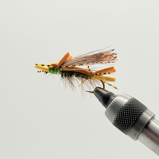 Fishing fly lure with orange-brown body, green head, and trailing hackle fibers