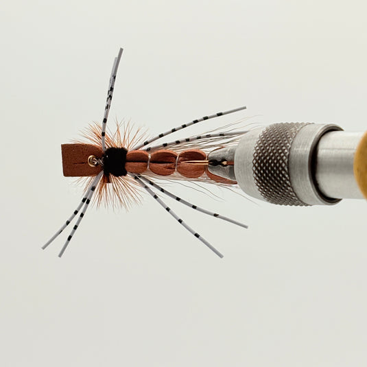 Brown foam hopper fly with maroon-brown foam body, barred legs, and bushy hackle