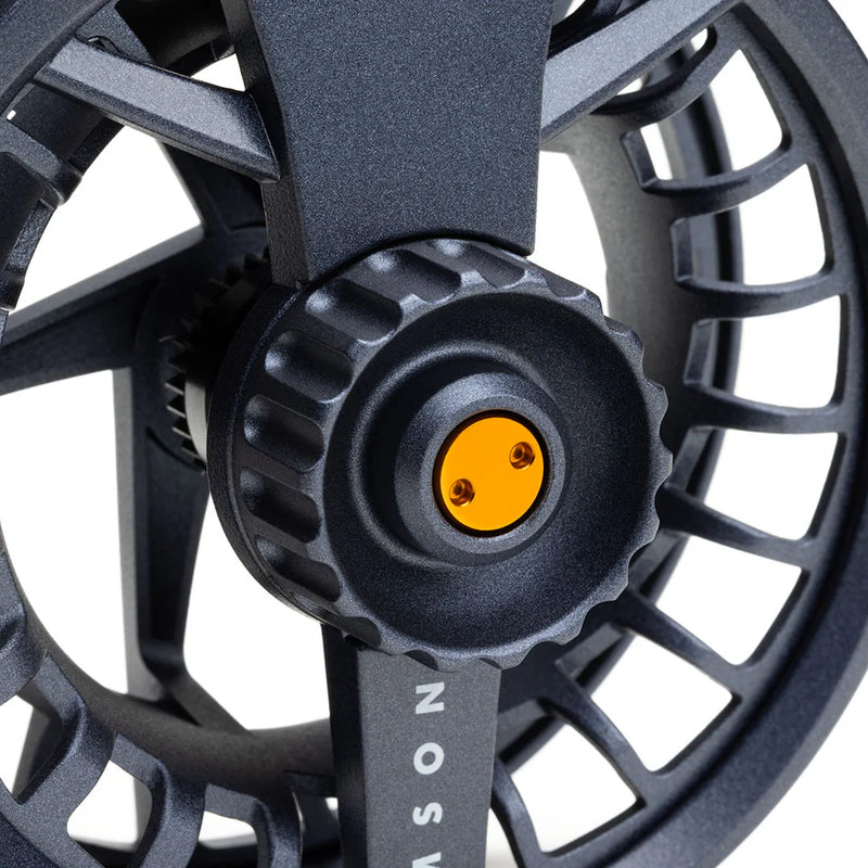 Load image into Gallery viewer, Fly fishing reel close-up: dark gray center cap with yellow insert and screw detail
