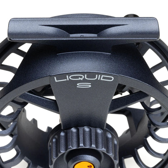 Fly fishing reel top front view with "LIQUID S" badge and dark gray spool guard
