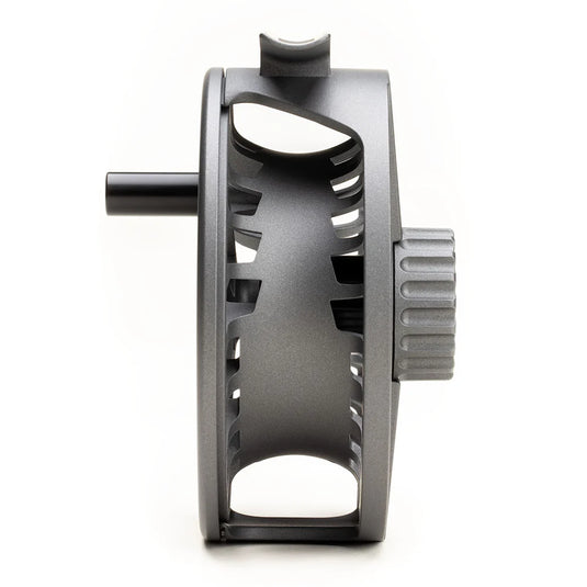 Fly fishing reel side view with dark gray frame, open cutouts, and ridged adjustment