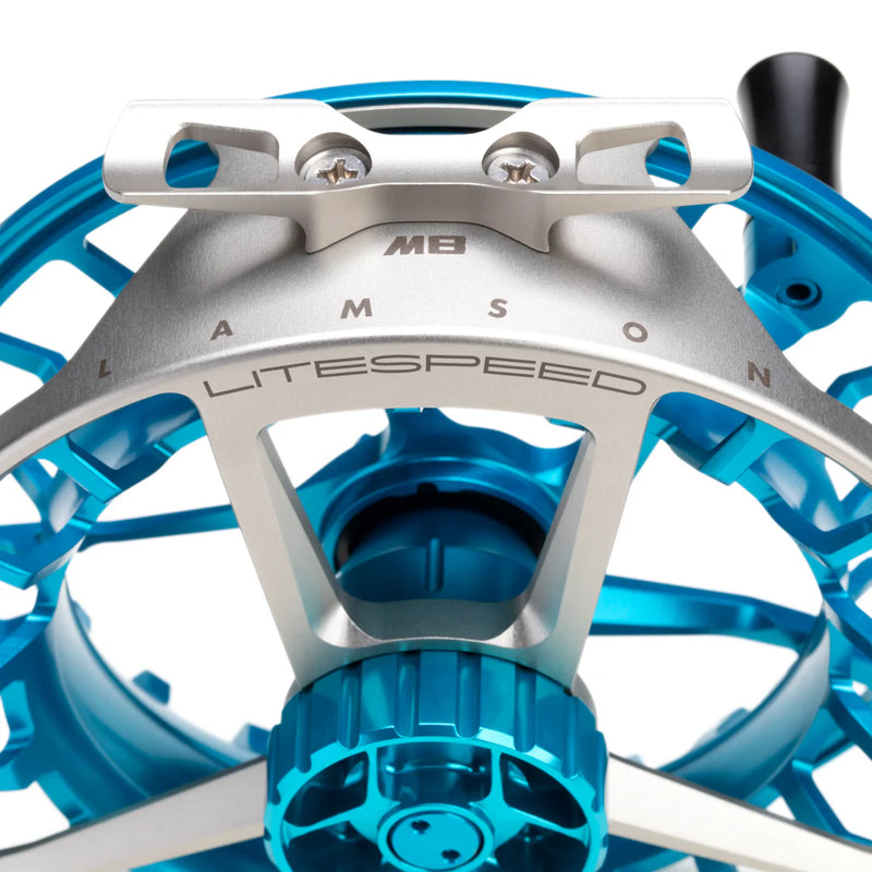 Load image into Gallery viewer, Fishing reel close-up of engraved ring with blue spool components below

