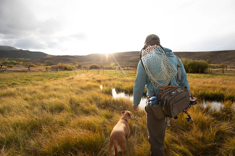 Load image into Gallery viewer, Fishing guide pack worn at the waist, gray pouches and chest straps

