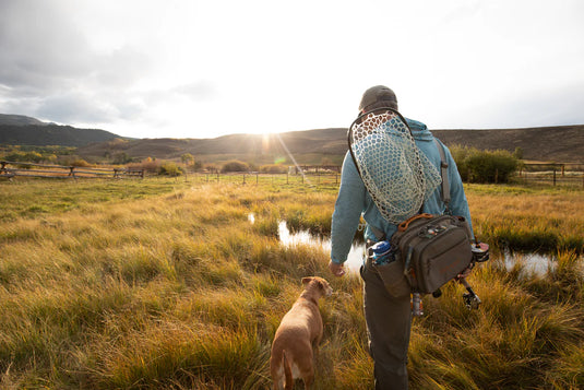 Fishing guide pack worn at the waist, gray pouches and chest straps