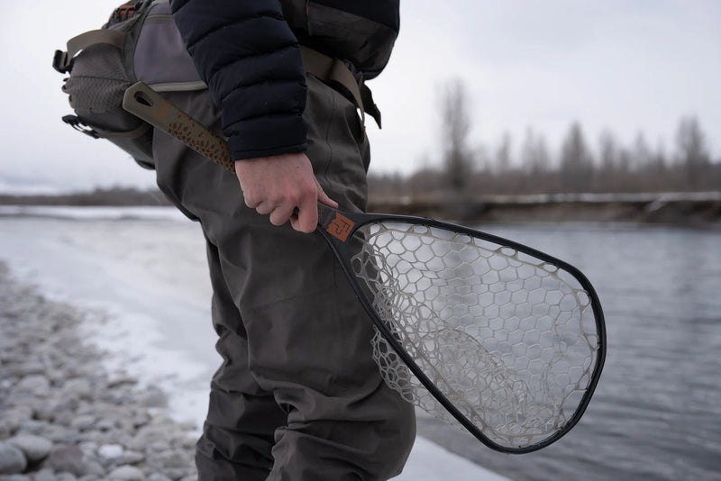 Load image into Gallery viewer, Fishing net with white mesh and brown handle in an oval frame, outdoors
