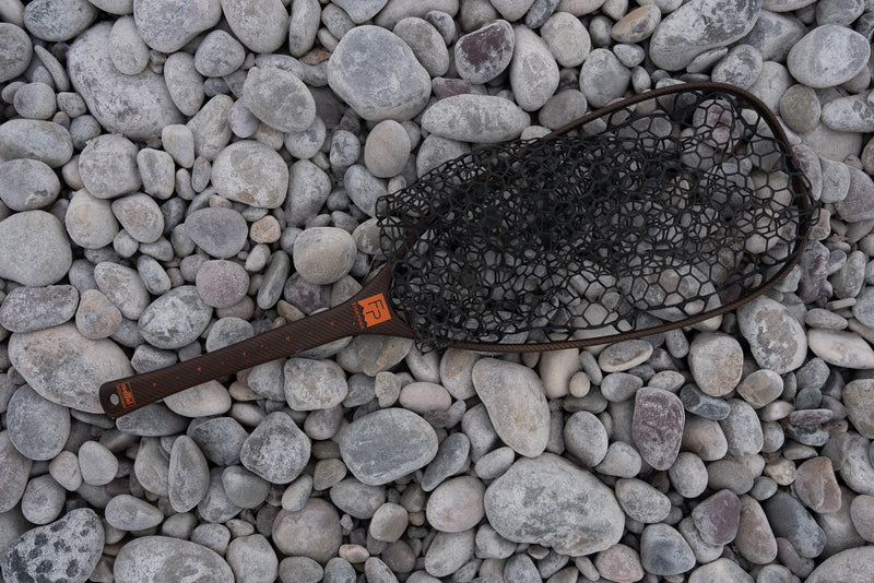 Load image into Gallery viewer, Landing net with black hex-mesh bag and dark brown handle on rocks
