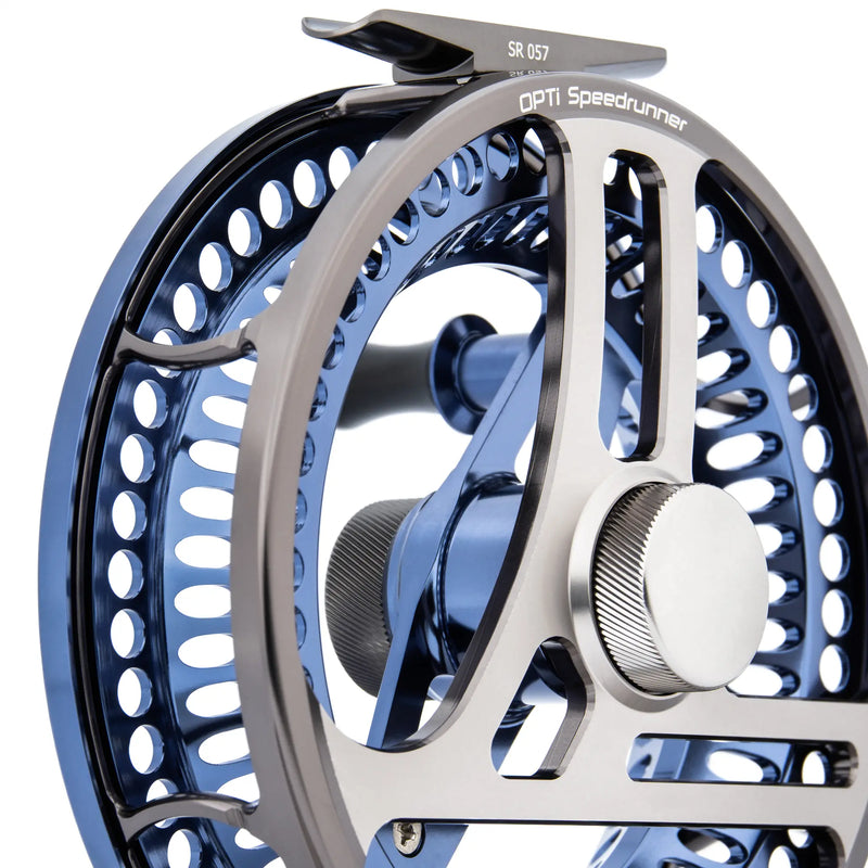 Load image into Gallery viewer, Fishing reel close-up with blue perforated rim, silver accents, and dual knobs
