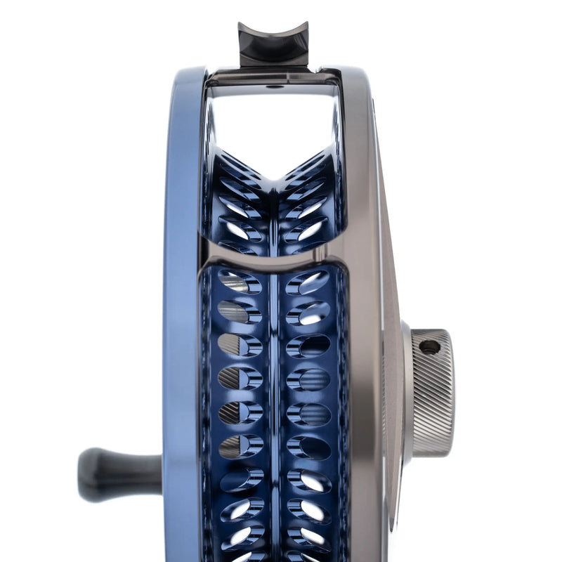 Load image into Gallery viewer, Fishing reel with chrome frame, dark blue spool, and textured black handle
